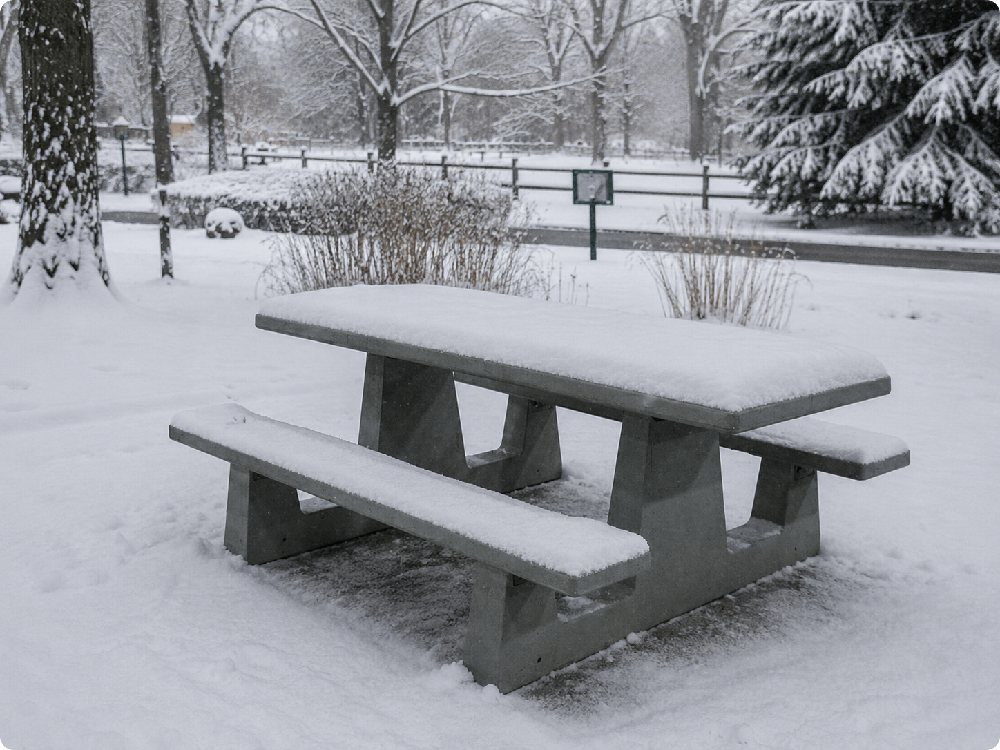 Concrete picnic table in a snowy outdoor setting